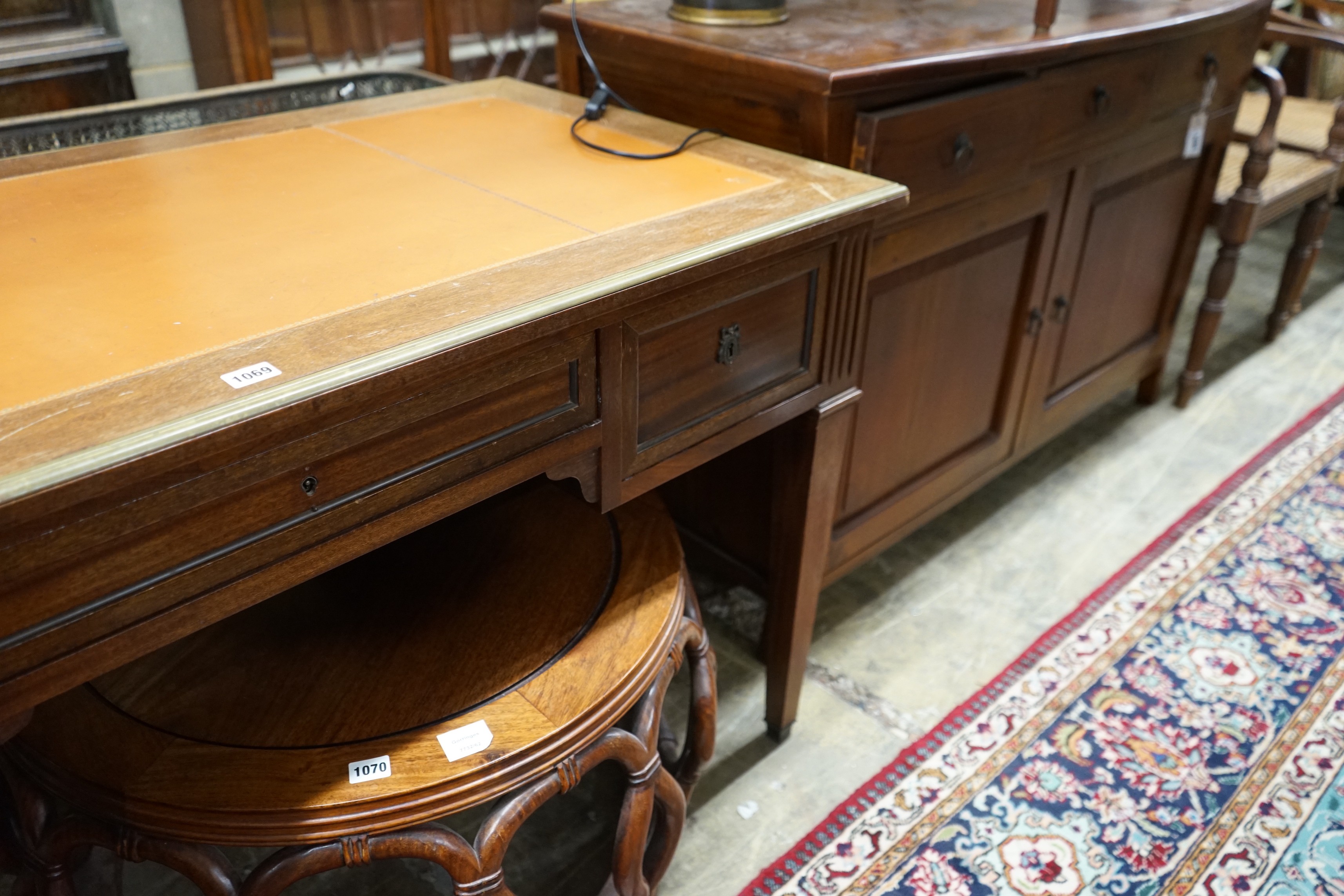 An Empire style brass mounted mahogany kneehole desk, width 130cm, depth 66cm, height 76cm